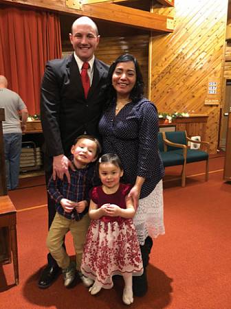 Scott West stands with his wife, Flor Maria, his son, Benjamin, and his daughter, Leah.