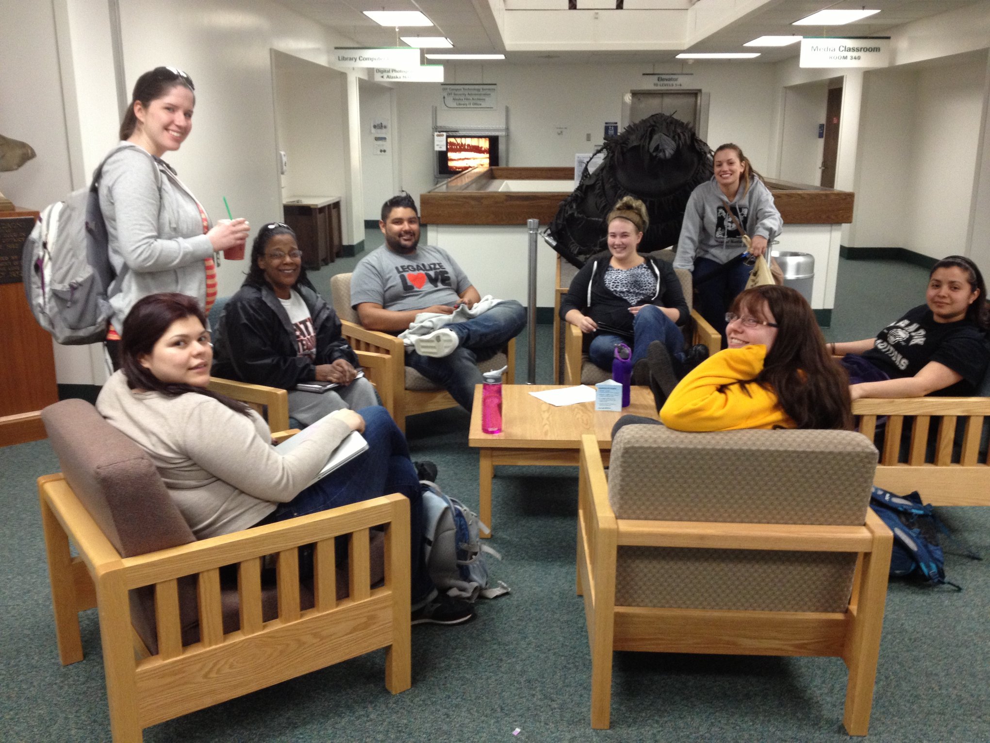 Social Work students relax around a table during a meeting