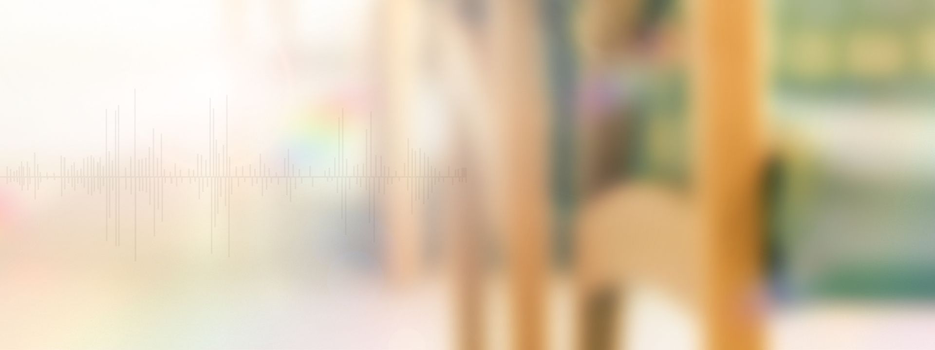 A hazy, blurred photo of chairs in a hospital waiting room, overlain with light leaks. Graphic by Kat Reichert