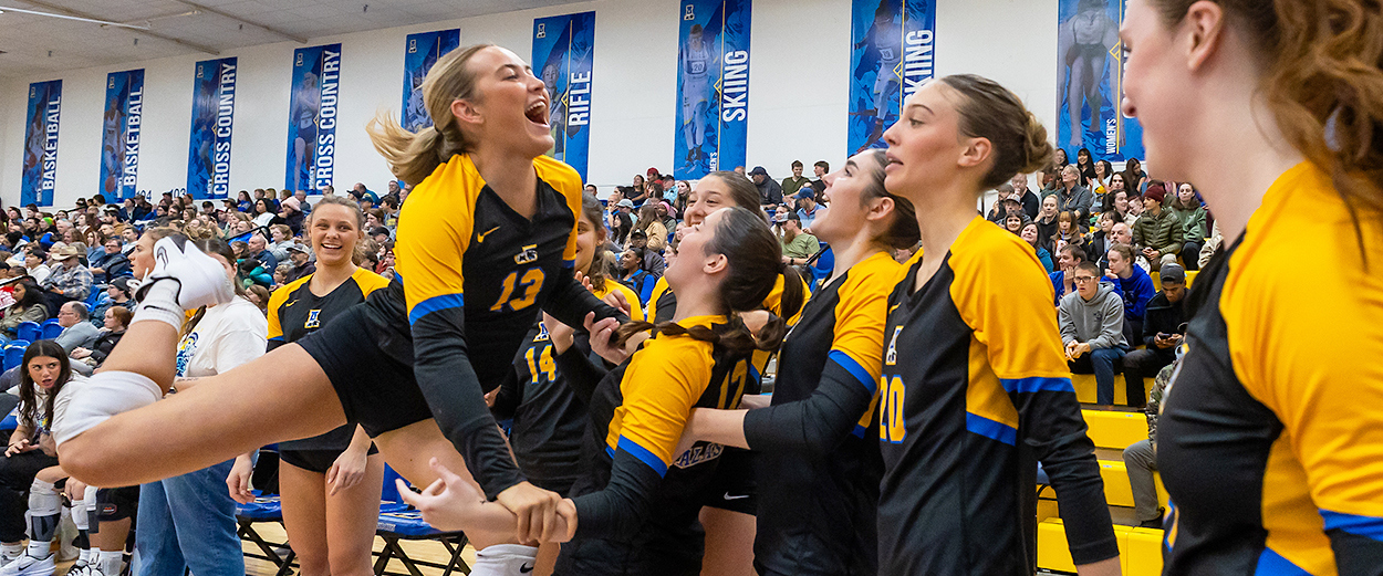 The Nanook women's volleyball team celebrates at the final game of the Denali State Bank Ice Block Classic volleyball tournament.