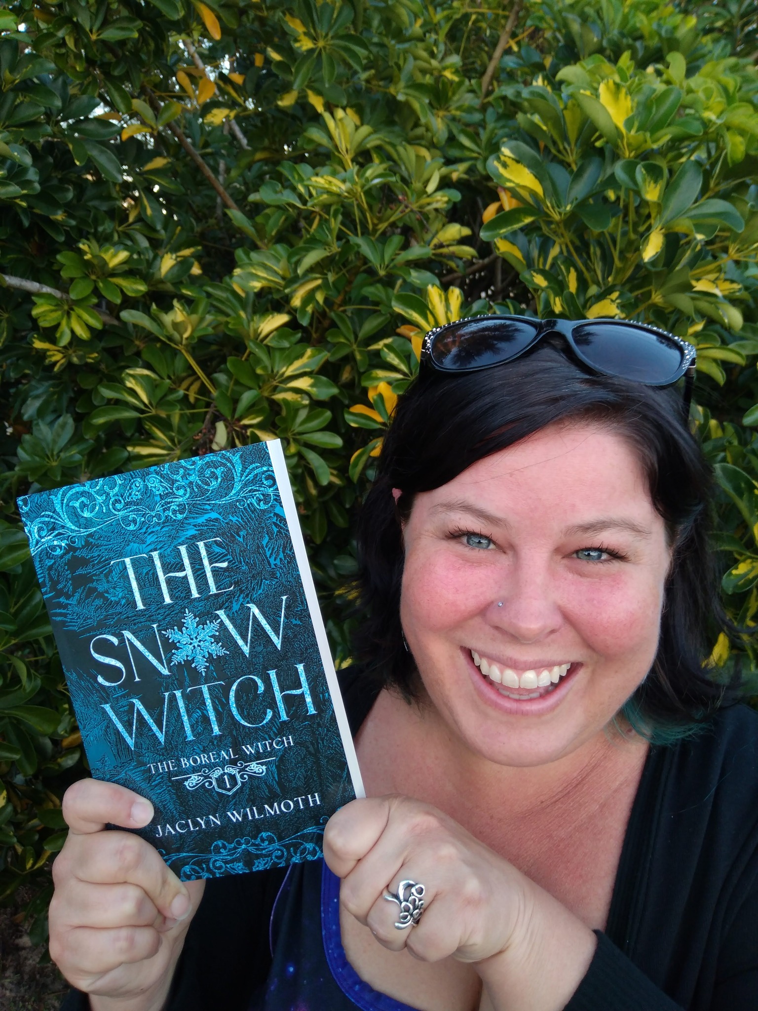 Jaclyn Bergamino, (pen name Jaclyn Wilmoth), holds the paperback copy of her first novel, The Snow Witch. Photo Courtesy of Jaclyn Bergamino.