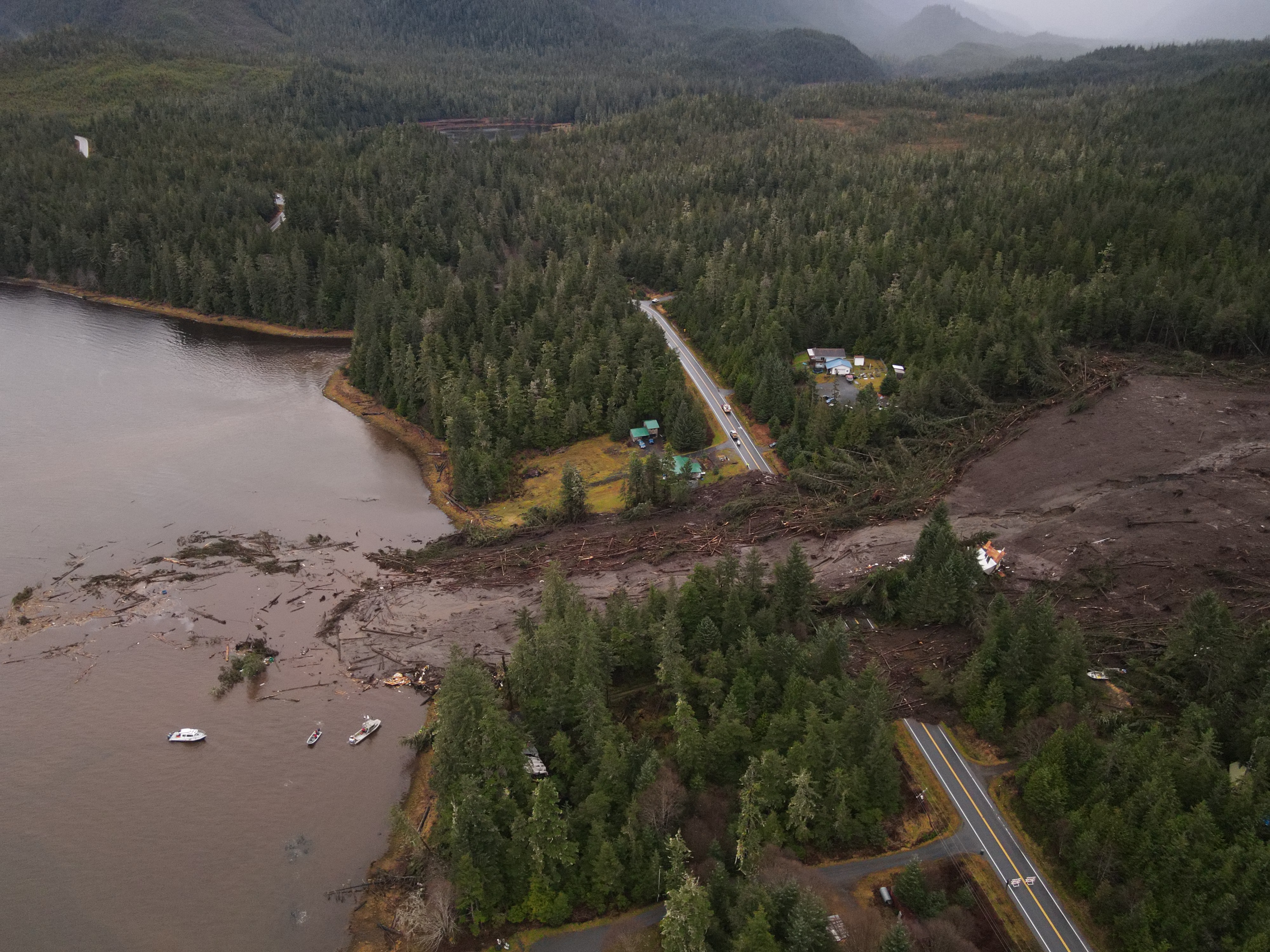 Aerial shot of a landslide that washed out houses and a section of highway.