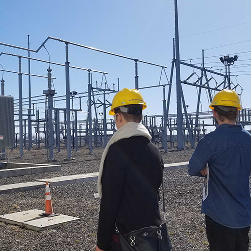 Two men near a power system