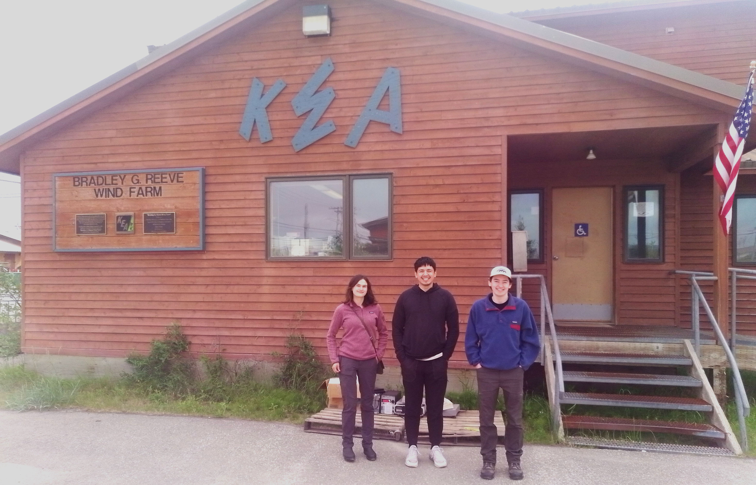 Joy Lomelino, RJ Michael and Solomon Himelbloom pose for a photo in front of the KEA building.