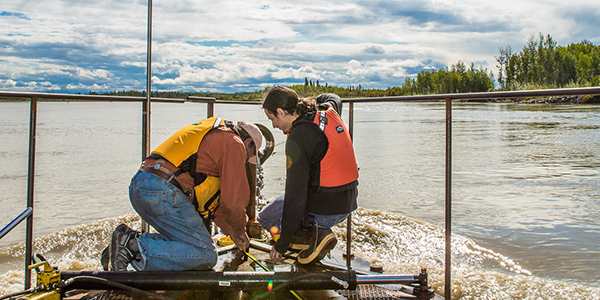 ACEP’s marine energy team works at the Tanana River Hydrokinetic Test Site