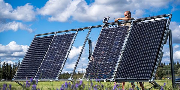 Cole Sudkamp-Walker works on a solar panel at ACEP’s Solar Photovoltaic Test Site in Fairbanks.