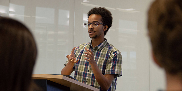 ACEP intern Dominique Hinds gives a presentation on his project on converter-dominated power systems. Photo by Yuri Bult-Ito/ACEP.