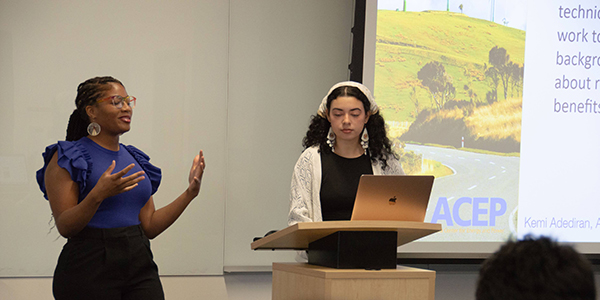 ACEP interns Kemi Adediran and Arana Rodriguez give a presentation on their community resource work. Photo by Yuri Bult-Ito/ACEP.