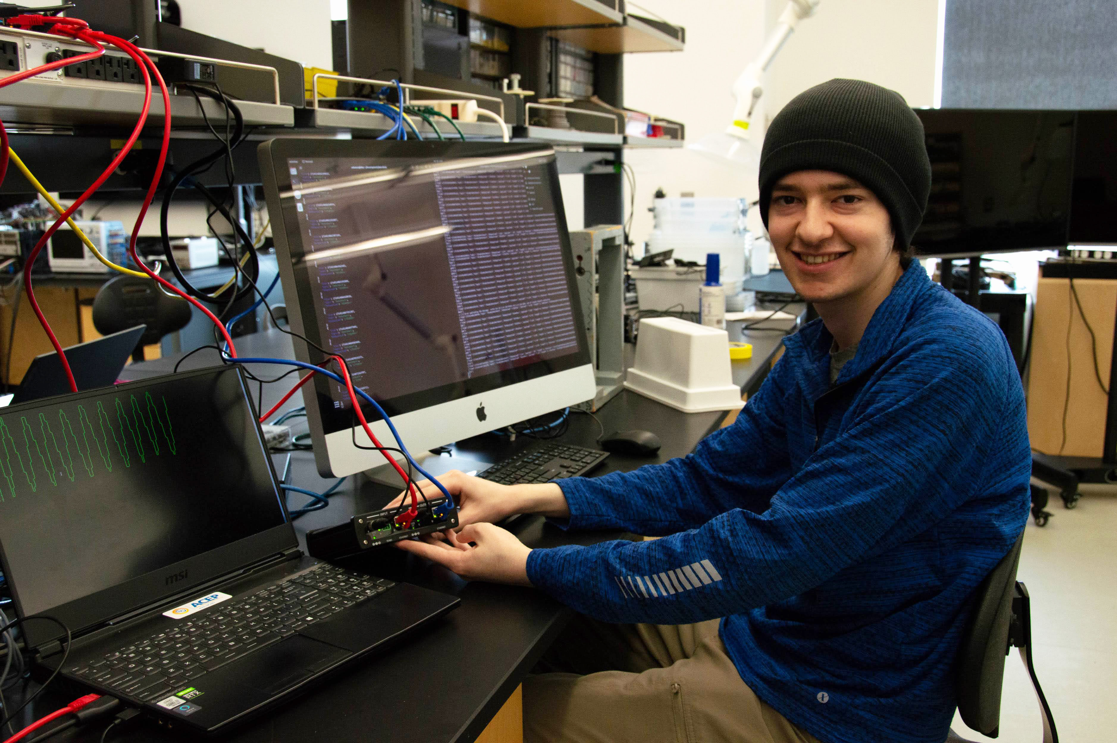 Solomon Himelbloom holds a data diode while working in ACEP’s lab.