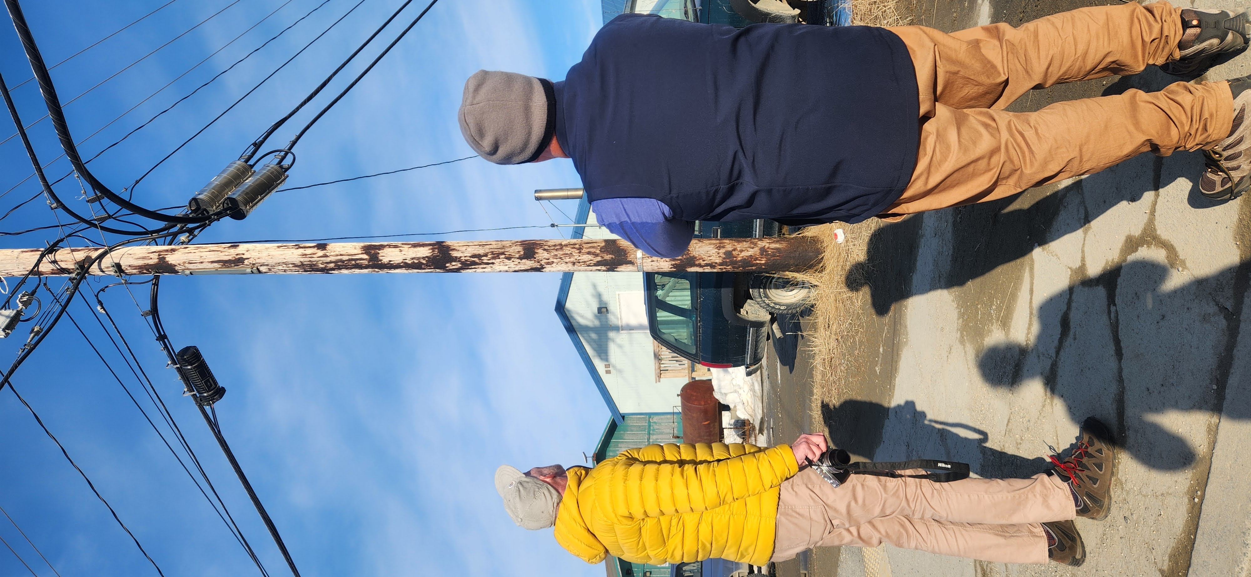David Edwards and Peter Kempster take interest in the different power pole configuration in Kotzebue.