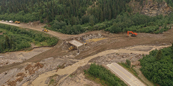 laska Department of Transportation and Public Facilities works to repair Bear Creek Bridge on the Richardson Highway after high rainfall caused the creek to wash away the road. Photo by Alaska DOT. 