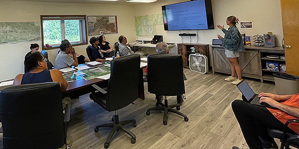 Chase Hetler gives a presentation on the Power Cost Equalization program to the Minto Tribal Council. Photo by Erika Loebrich/ACEP.