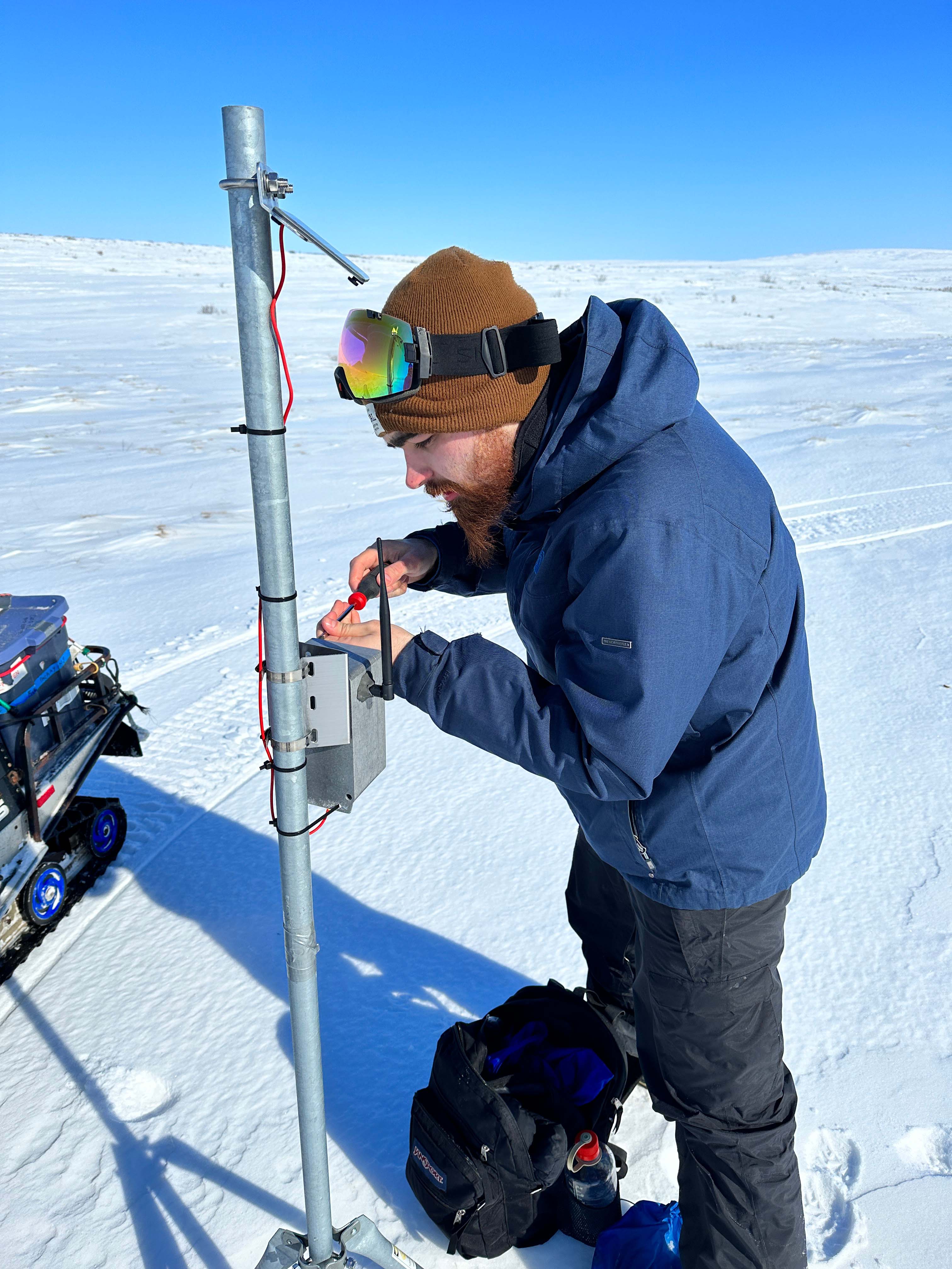 Henry Toal works on a remote solar irradiance sensor in Kotzebue.