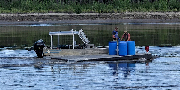 Eli Willett (left) and Leo Azizi (right) work at the Tanana River Test Site. Photo by Stephanie Fisher.