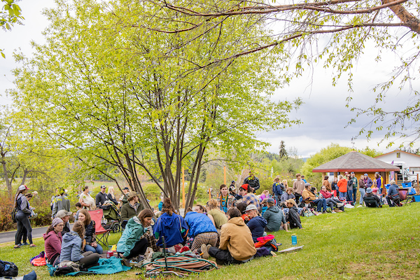 Large group of people sitting in a field