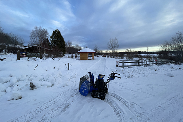 snow blower on a path at the garden