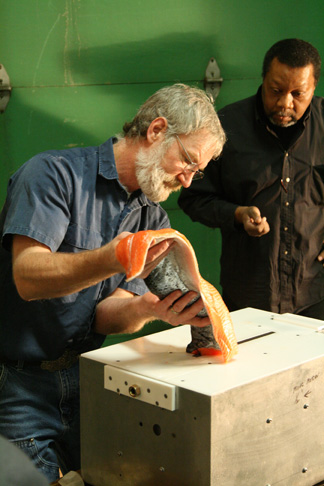 GI machine shop assistant manager Tim Manning demonstrates the Pinbone Wizard machine in 2007 while shop manager Greg Shipman looks on.