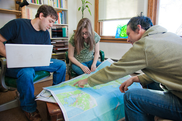 Anthropology Faculty Graduate students Gerad Smith, left, and Nickole Robarge meet with anthropology faculty member Patrick Plattet in his Eielson Building office. | UAF Photo by Todd Paris
