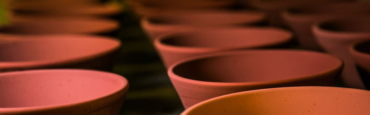 Rows of red ceramic bowls