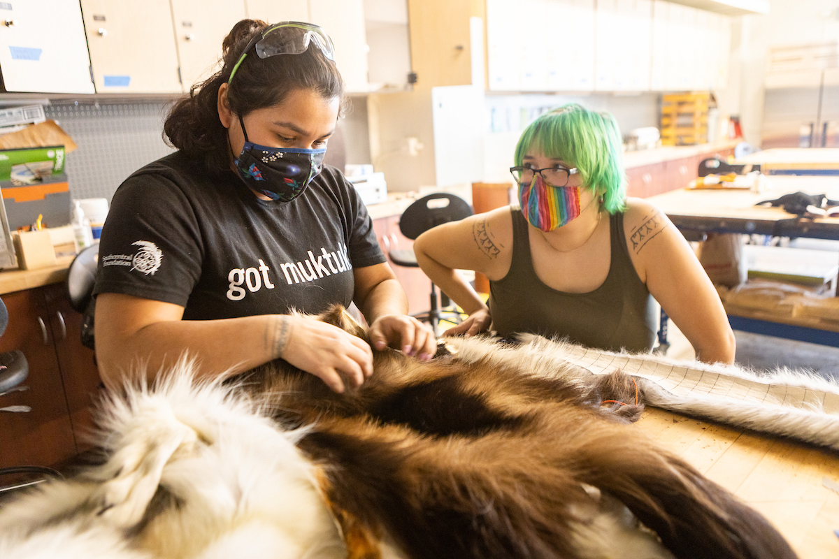 Two students work with fur in the Native Arts Studio. UAF Photo by JR Ancheta