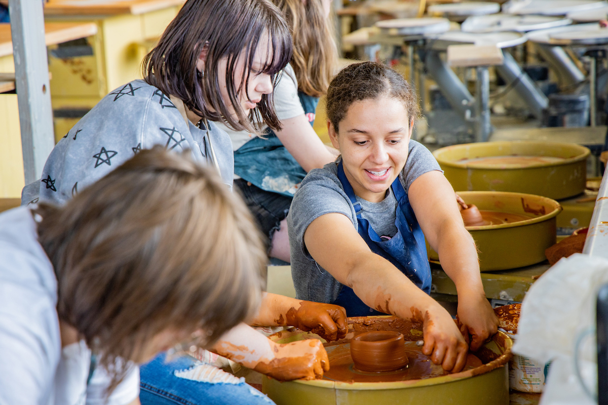 Instructor Shaylise Sylvester helps a student with her ceramic piece at the 2024 Summer Visual Arts Academy on Wednesday, June 12, 2024. UAF Photo by Marina Santos.