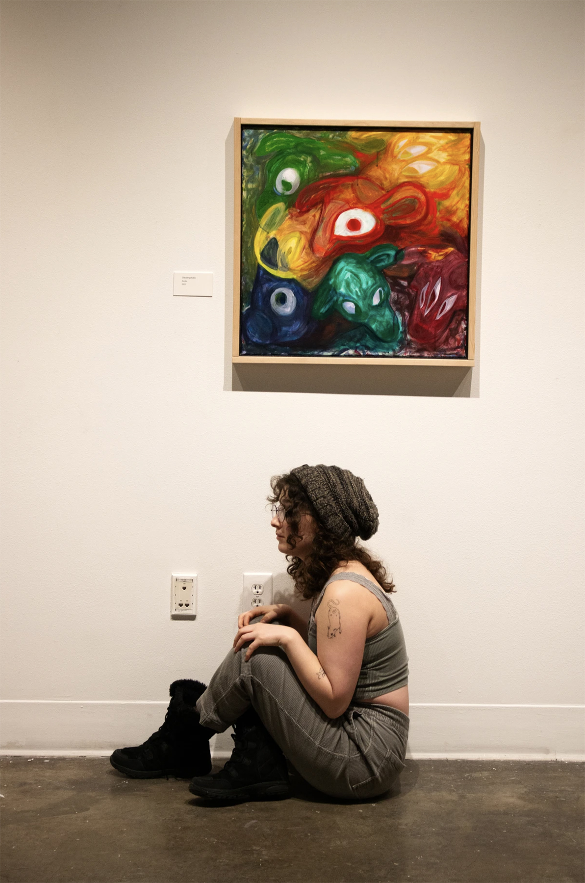 Chana Stern poses under Claustraphobic at the reception for "Pilgrimage of the Revenant", courtesy of the artist