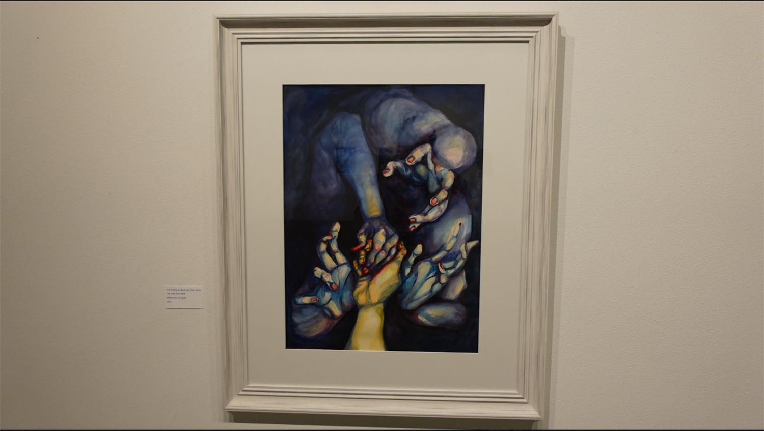 A framed painting hangs on the wall of the UAF Art Gallery during Daniell Stromanthe's BFA exhibition, Painful Yet Tender. image courtesy of the artist