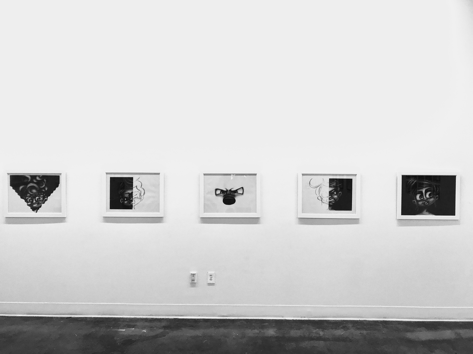 Digital prints hang on the wall during David Glover's thesis show, Art of the Mudsuckle Ritual, image courtesy of the artist