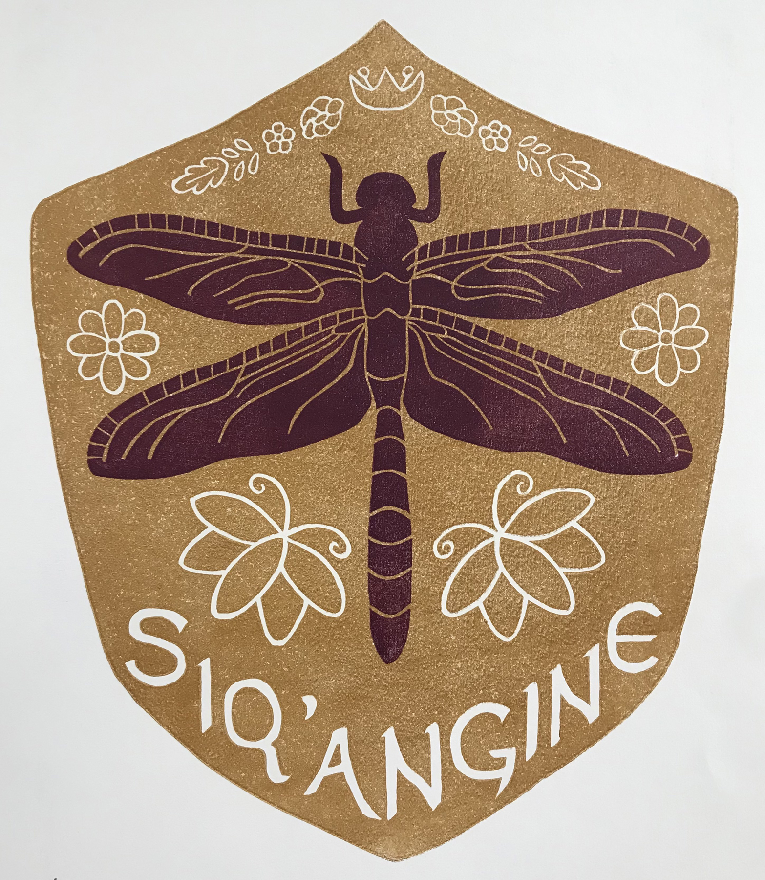 Two block relief print of a yellow shield with a maroon dragonfly and the word Siq'angine at the bottom, courtesy of the artist