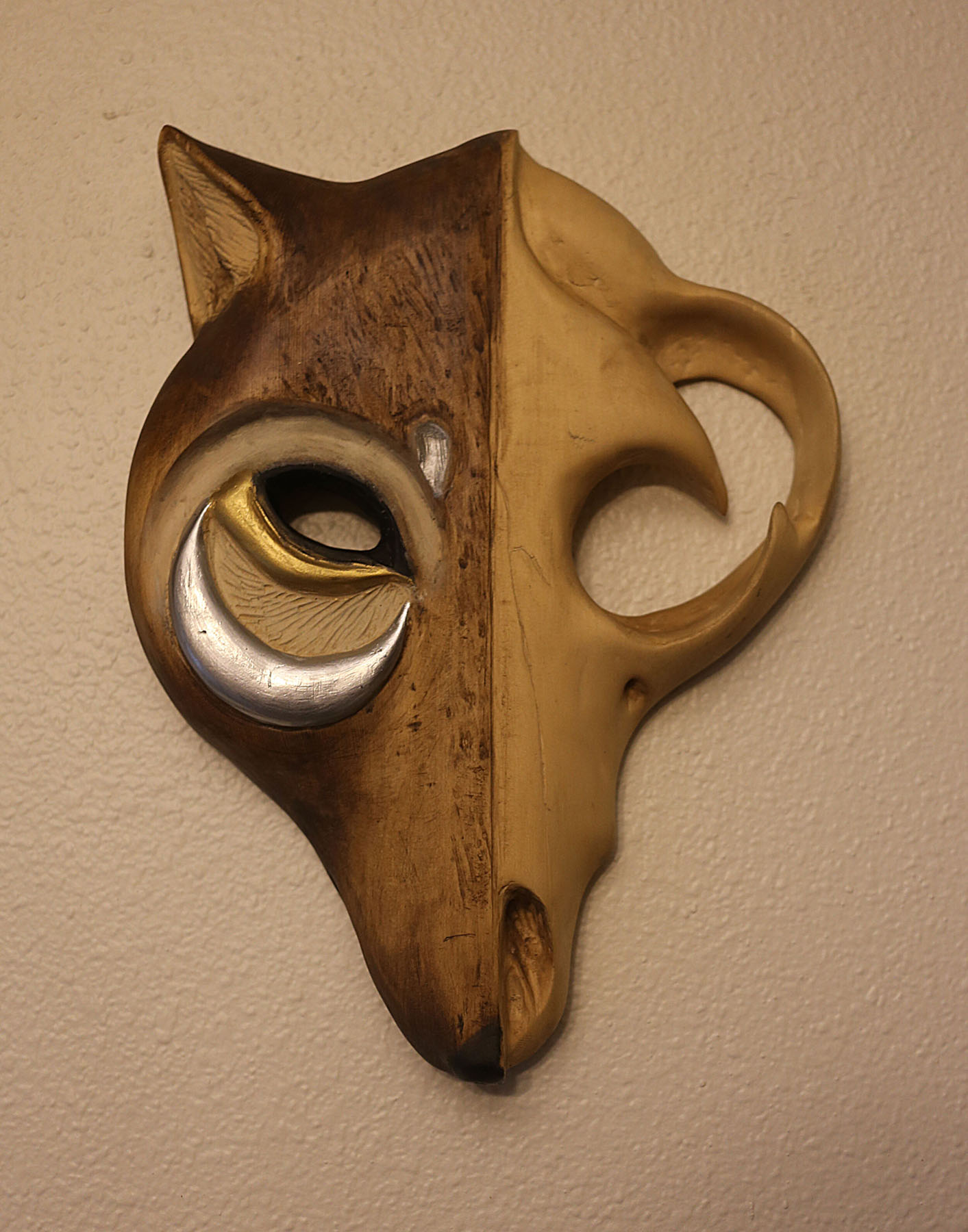 Animal face carving in yellow Cedar, adorned with acrylic paint and alcohol ink. Image courtesy of Indi Walter