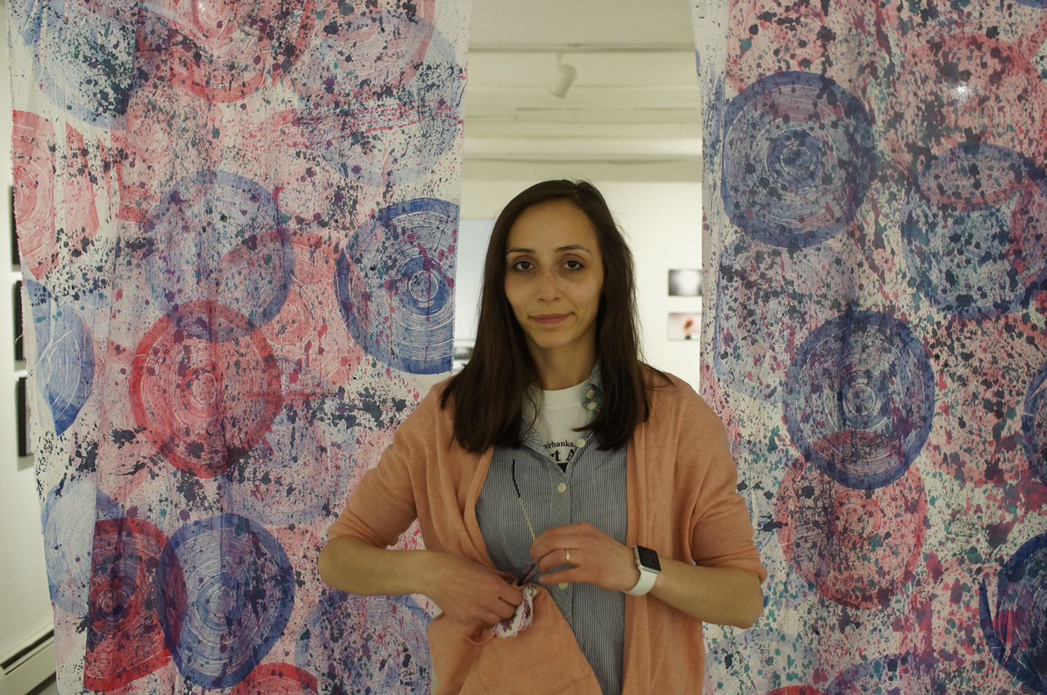 Naomi Hutchquist poses at the entrance to her 2019 BFA thesis exhibition, Wheels of Life, held at the Well Steet Art Company gallery. Image courtesy of Naomi Hutchquist