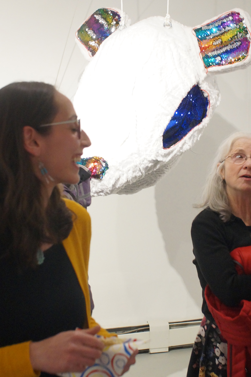 Naomi talks with attendees of her gallery opening of her BFA thesis exhibition Wheels of Life. Image courtesy of Naomi Hutchquist 