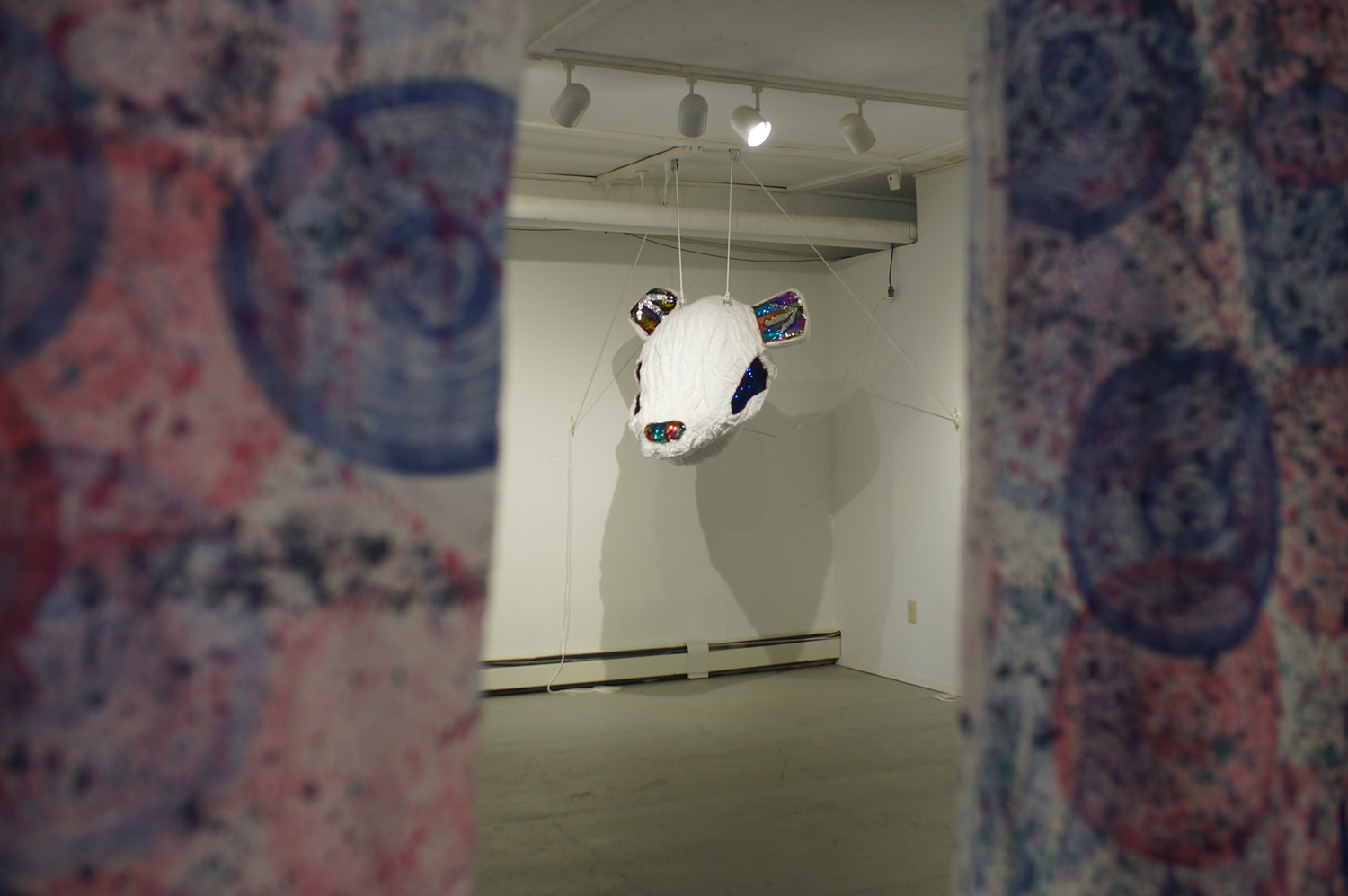 "Who Are You? Who Am I?" sculptural piece viewed between two cloths at Naomi Hutchquist's BFA thesis exhibition at Well Sreet Art Gallery in 2019. Image courtesy of Naomi Hutchquist