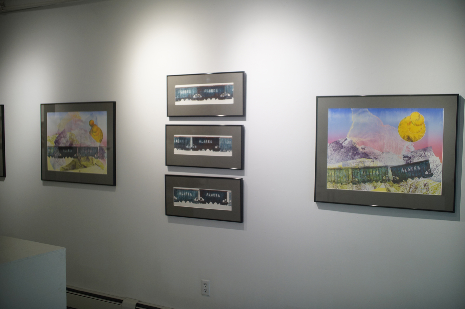A wall of monoprints featuring Alaska coal cars at Naomi Hutchquist's BFA exhibition, Wheels of Life. Image courtesy of Naomi Hutchquist