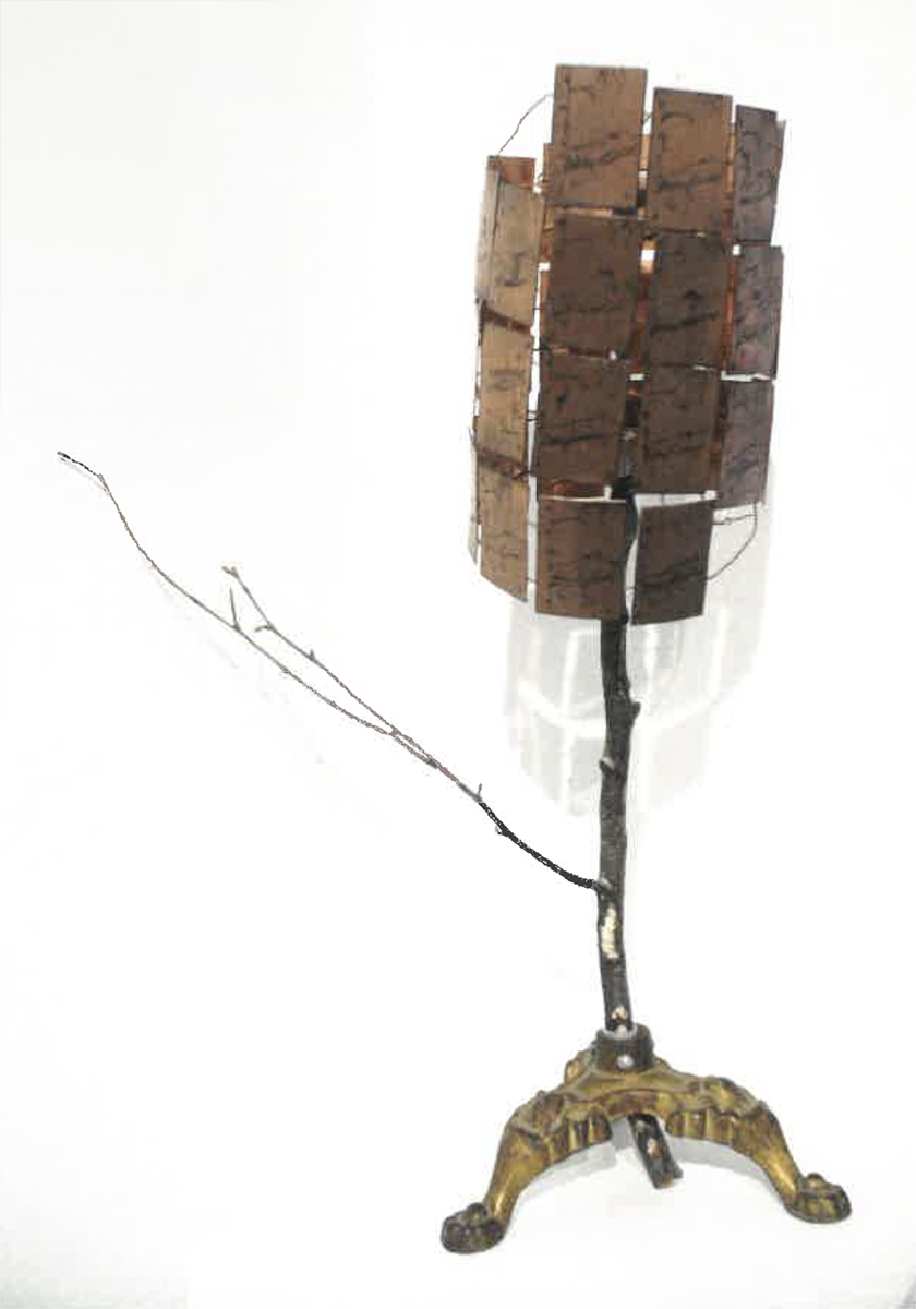 Found object sculpture of a tree with copper plate adornments. Image courtesy of Naomi Hutchquist