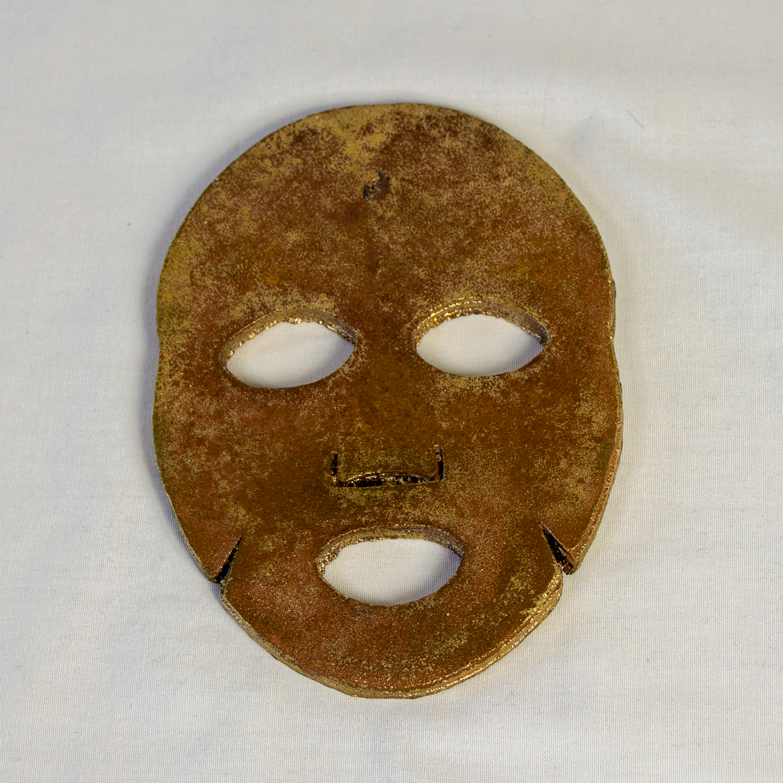 A broze face mask, courtesy of the artist