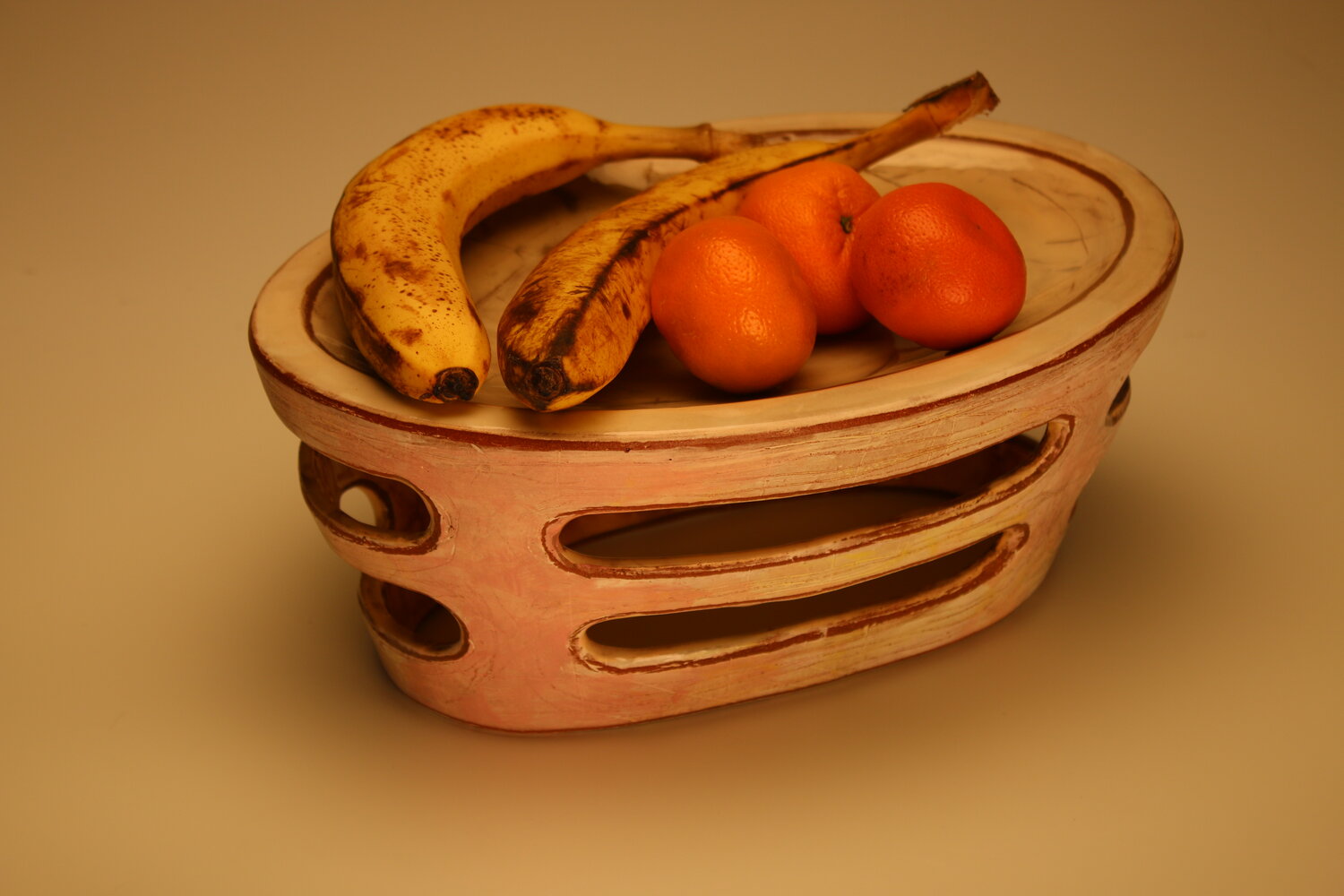 fruit on top of the reversible oval dish with oblong perforations, image courtesy of the artist