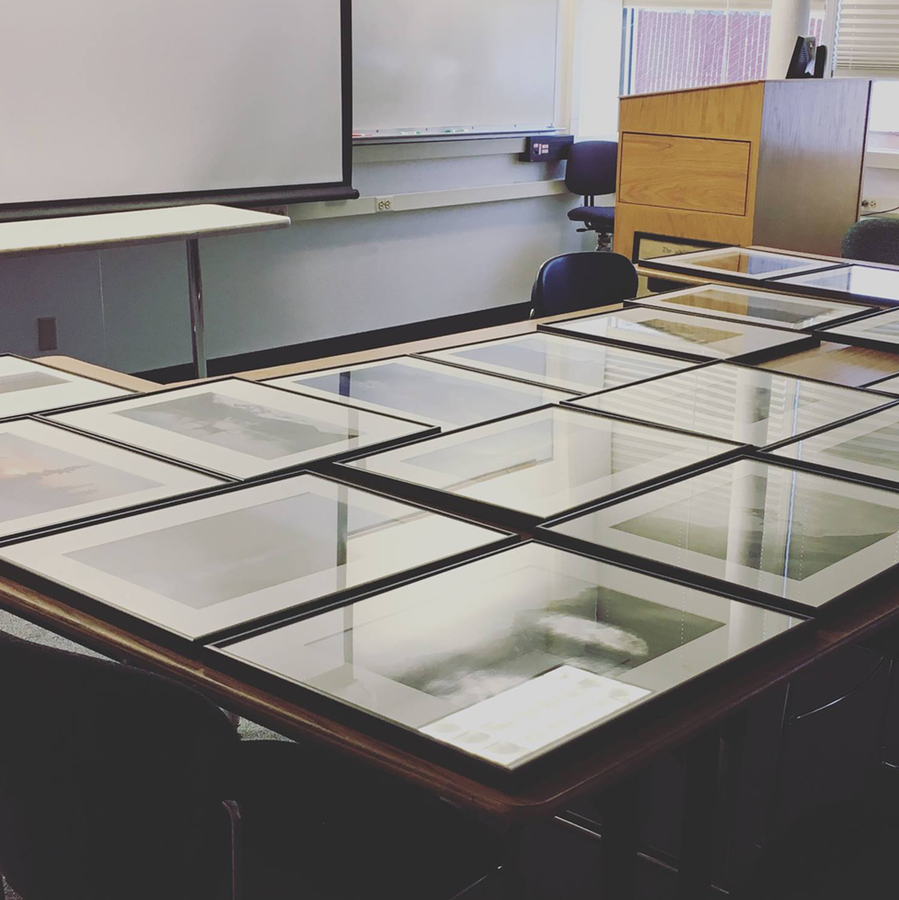 Frames laid out on desks in preperation for an exhibition. Photo courtesy of UAF Frozen Lenses Photography Club