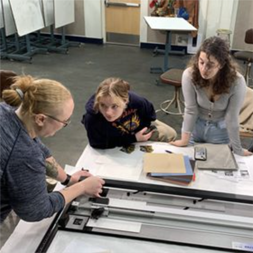 Allison Juneau leads a ready-to-hang matting and framing demo for UAF students in 2023. Photo courtesy of the UAF Department of Art