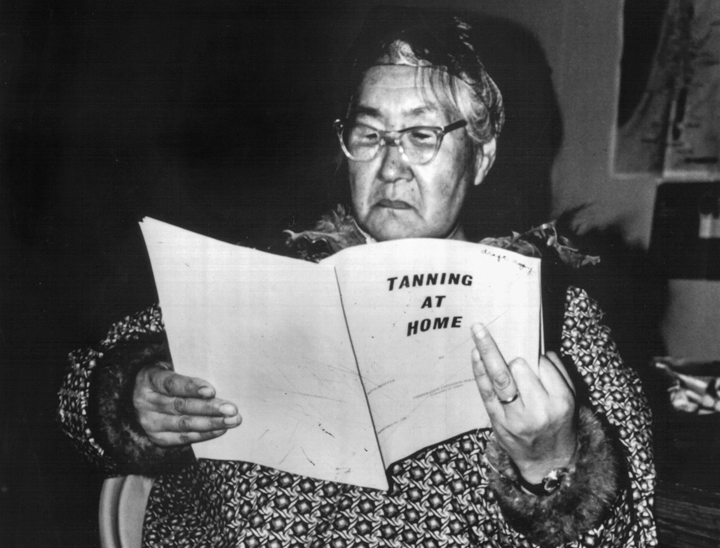 An unidentified woman reads a Cooperative Extension Service publication during a hide-tanning workshop offered sometime around 1980. Photo by Delores Hutchinson.
