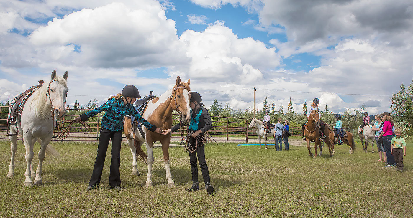 Fourteen-year-old Ainsley Smith, left, and her sister McKenna, 11, work with horses during a 4-H Club event organized by the Cooperative Extension Service at the Tanana Valley State Fair’s grounds in June 2017. UAF photo by JR Ancheta.