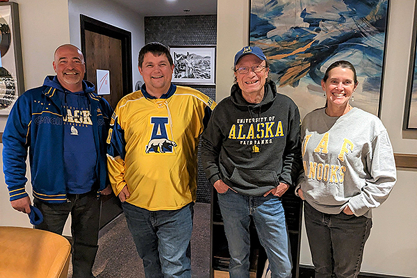 Alumni gather for a post-game social in Denver during the hockey series with Denver University in January 2023. From left are Dain Cunningham '93, Britton Anderson '10, Chet Paris '78 and Jane Paris.