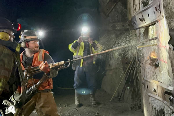 Student Erik Bach uses a jackleg drill in UAF's underground mine training camp near Delta Junction in November 2022. In the foreground is instructor Jim Smith. Instructor Sam Reves is in the background. Photo courtesy of the UAF Mining and Petroleum Training Service