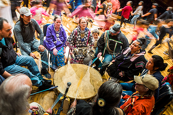 People sit in a circle to beat on a drum during the 2018 Festival of Native Arts. UAF photo by JR Ancheta.