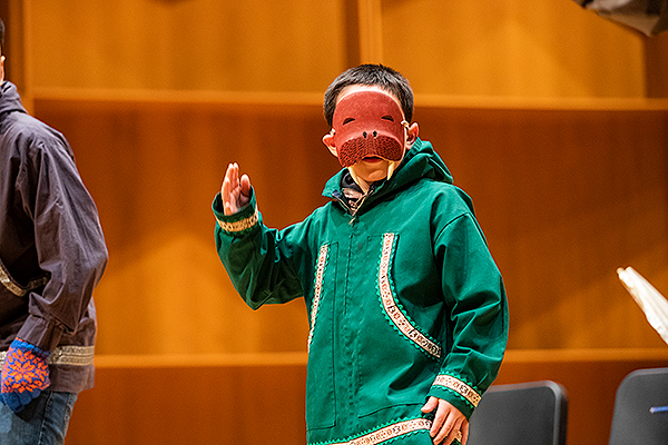 A child wearing a walrus mask performs on stage at the 2018 Festival of Native Arts. UAF photo by JR Ancheta.