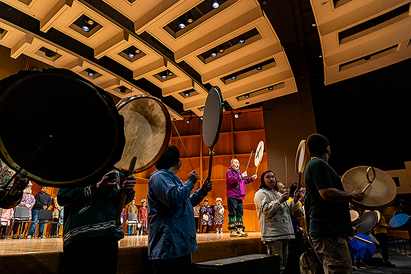 Performers with drums stand on and off stage during day three of the 2024 Festival of Native Arts. UAF photo by Leif Van Cise.