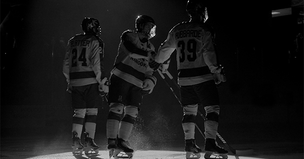 Hockey players in a dark setting