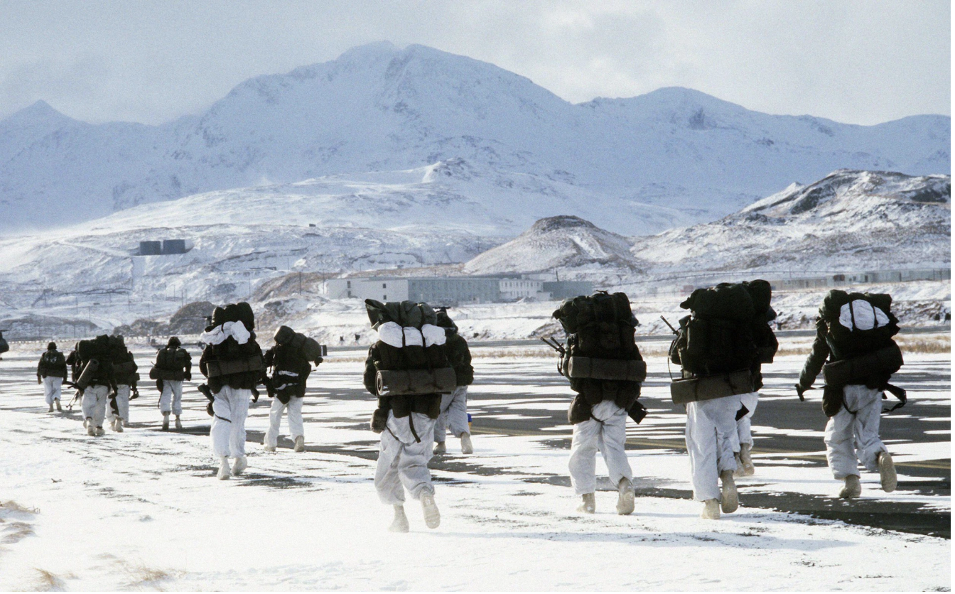 soldiers in white suits march in the arctic