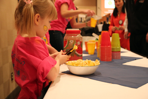 Dahlia, age 5, helps her family sell lemonade at a Rotary meeting to spread the word about Lemonade Day Alaska.