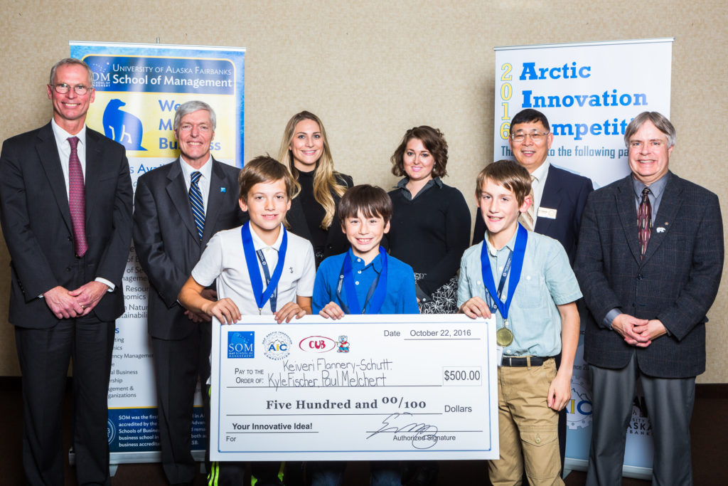 UA President Jim Johnsen, UAF Chancellor Dana Thomas, Paul Melchert, Allysa Wood of Kinross, Keiveri Flannery-Schutt, Celine Graas of Kinross, Kyle Fischer, Professor Ping Lan, and School of Management Dean Mark Herrmann pose with Cub grand prize check at the 2016 Arctic Innovation Competition.